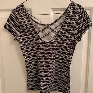 Medium black and white short sleeve shirt with criss cross back details.